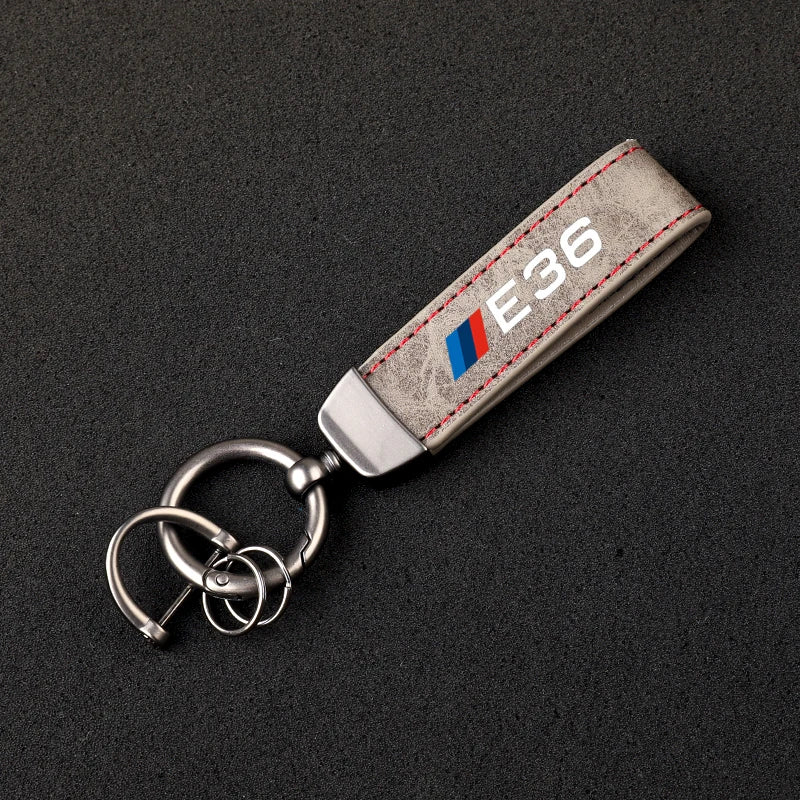 "BMW Logo Keychain: This sleek accessory features the BMW logo and functions as a keyring to securely hold your keys. Add style and sophistication to your daily routine with this authentic BMW product."