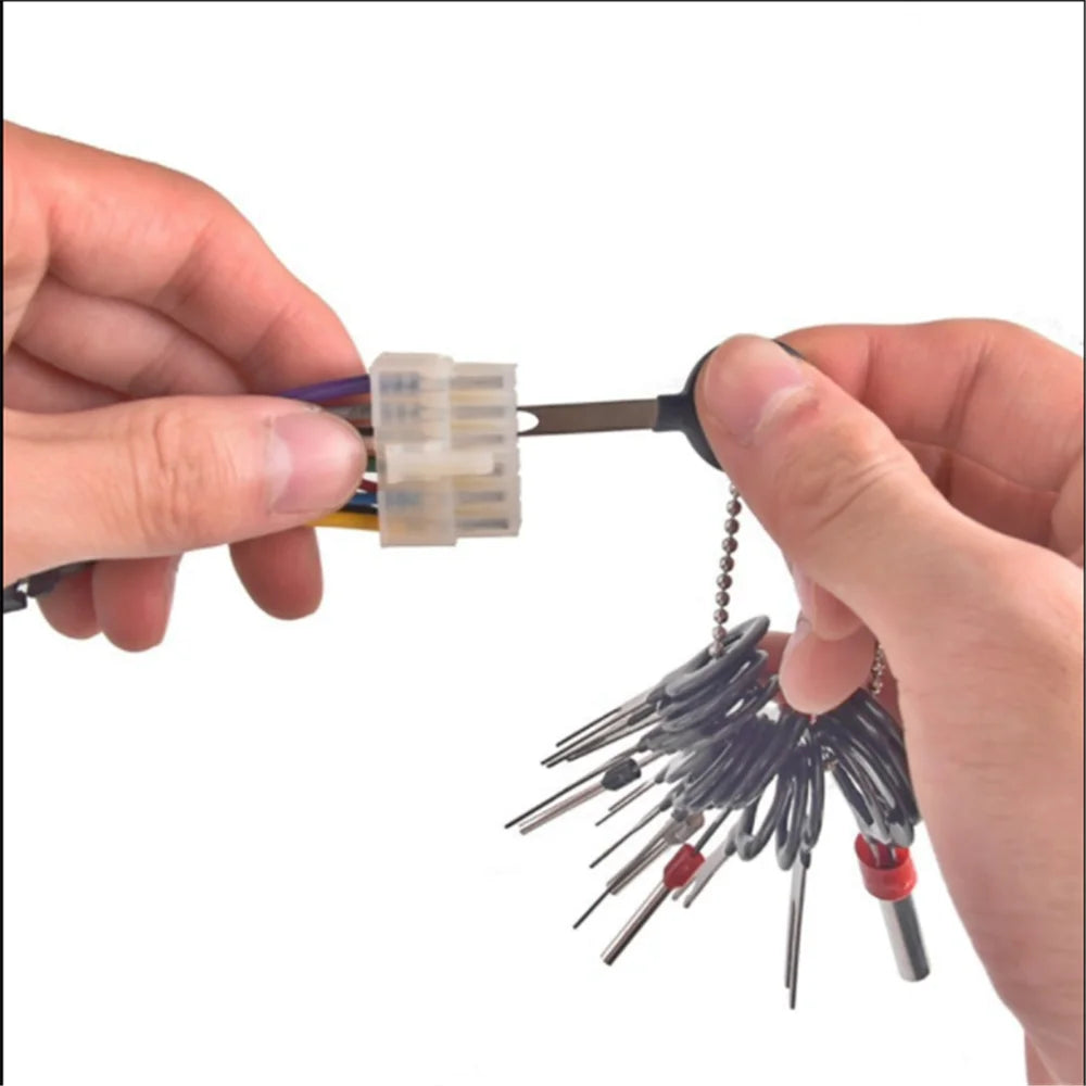 "Person holding BMW/VW ejector tool kit wires for Car Terminal connection."