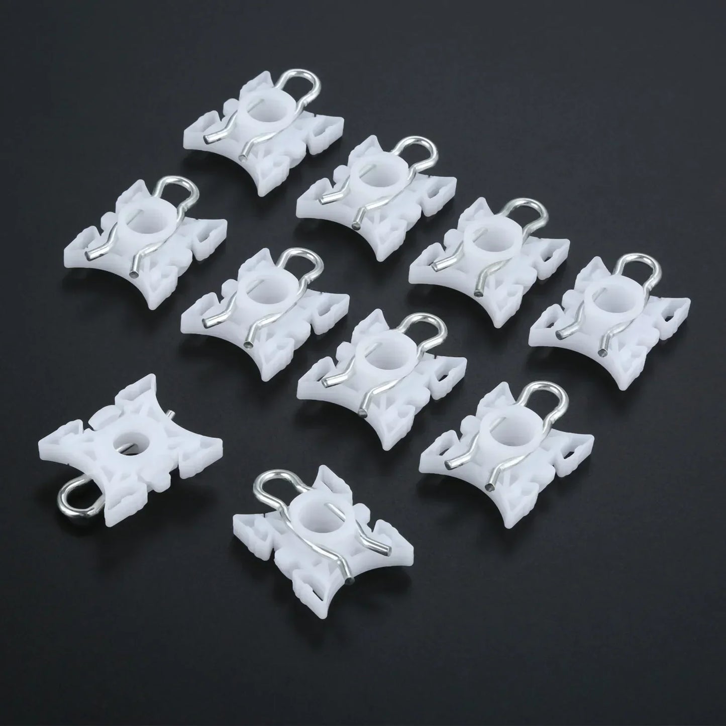 Ten white pivot clips for BMW E36 window regulators.