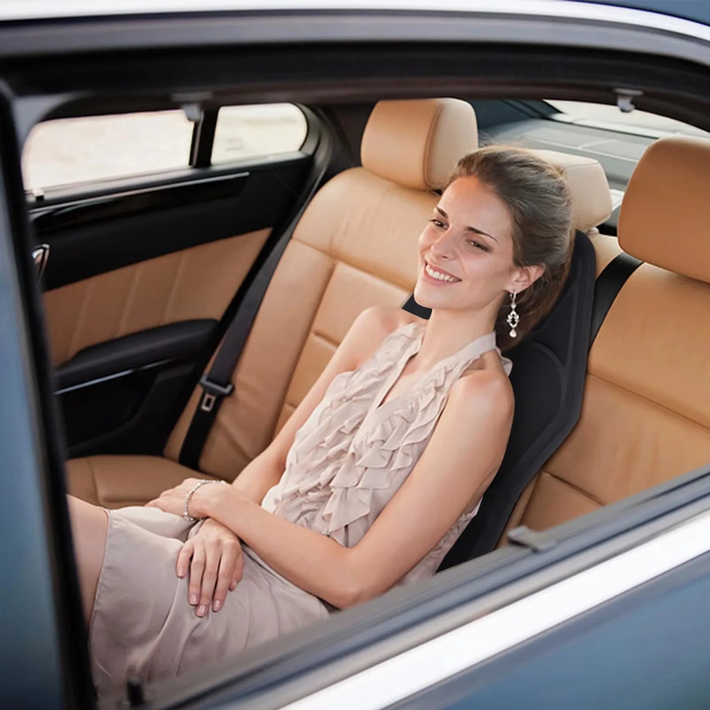 'Woman seated in vehicle with heated massage cushion. Nine adjustable modes for relaxation.'