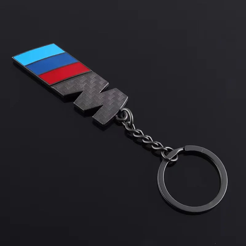 Flag-adorned keychain. This item features a small flag attached to a practical and portable keychain, ideal for securing keys while adding a personalized touch to your belongings.