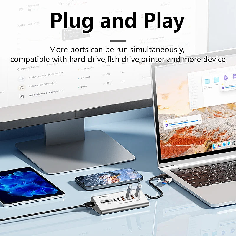 Laptop, phone, tablet on desk with USB-C docking station showing. Product: 10Gbps data transfer hub for multiple devices.
