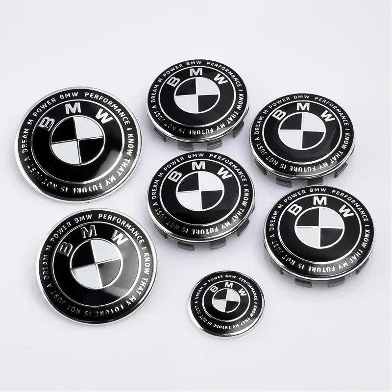 Seven BMW emblems for wheel centers in various sizes (45mm to 82mm).