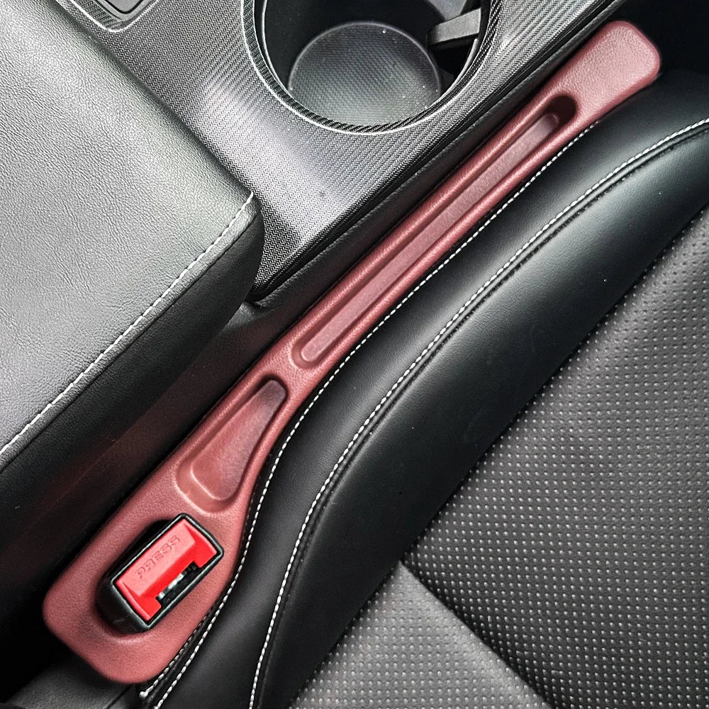 Red seat belt against beige car upholstery: Universal Car Seat Gap Filler in place.
