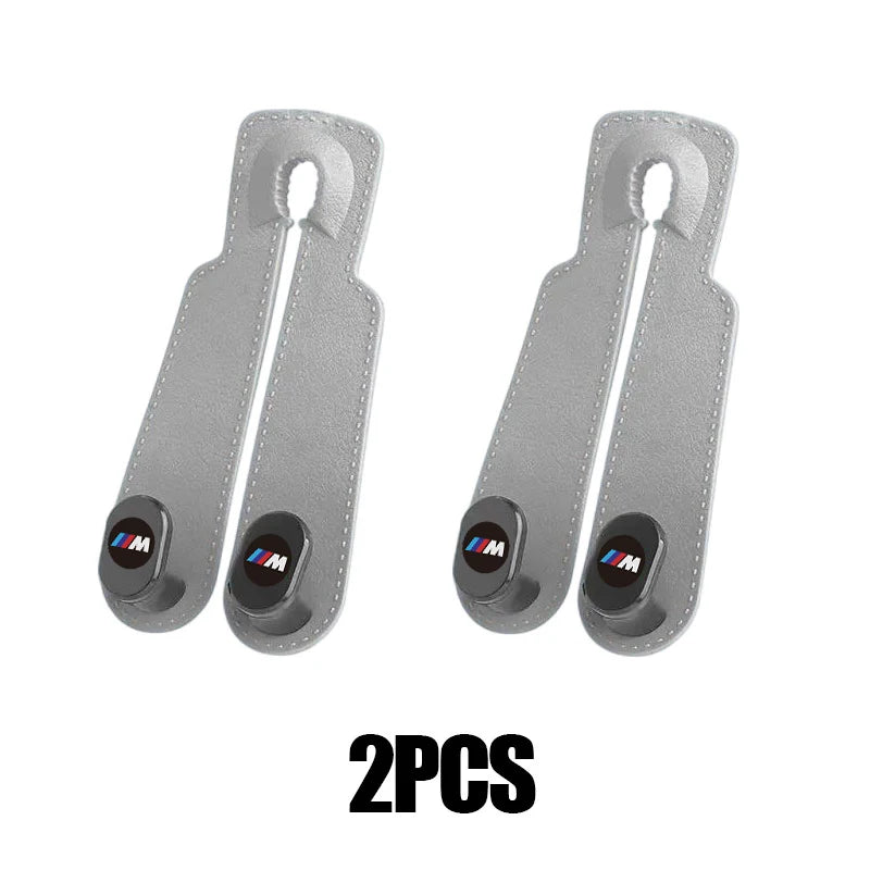 Two BMW E36, E39, E46 car seat headrest hooks with genuine leather handles.