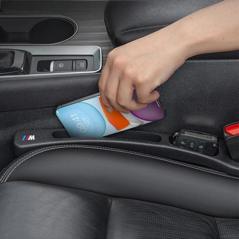 Two BMW seat gap fillers in use during car interior cleanup.