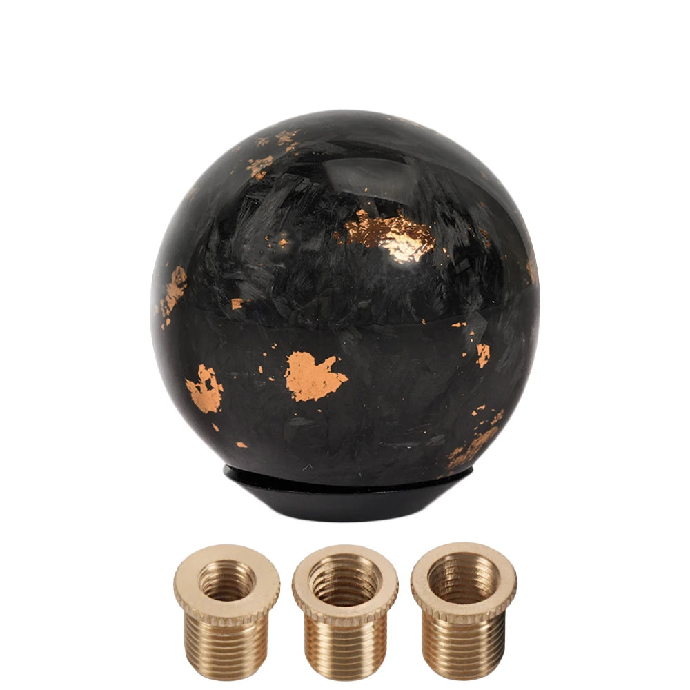 Black carbon fiber ball shift knob with gold accents and brass fittings. Fits manual and automatic vehicles. SFN165 model. Di
