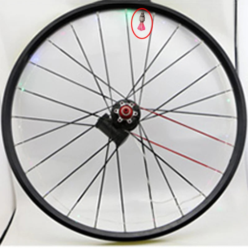 Red neon LED valve cap lights up one bike wheel, adds visibility at night. Replacement for standard caps. Fits most inner tub