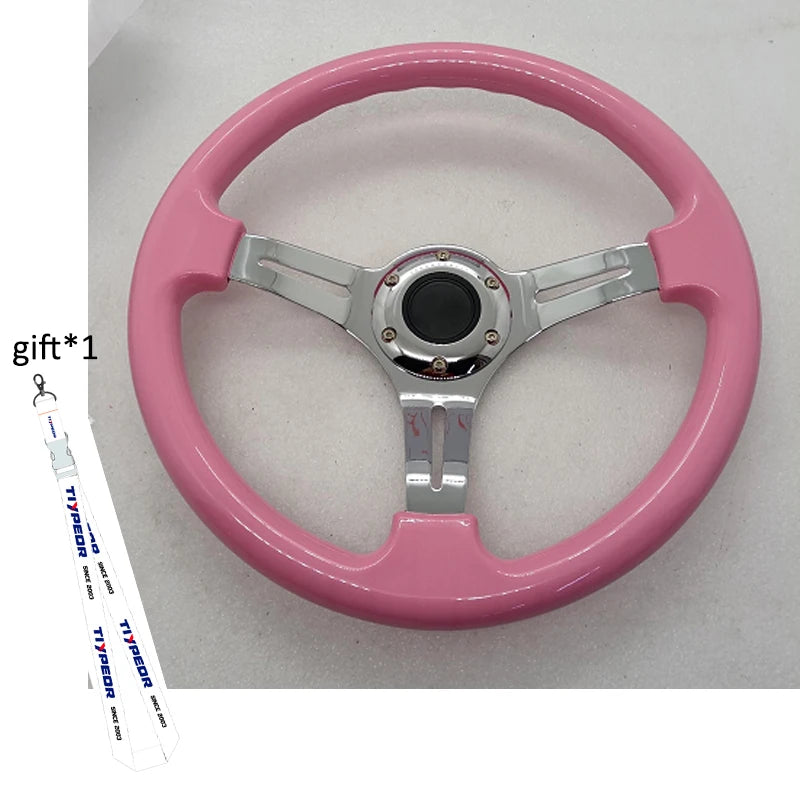 'Pink 14'' ABS steering wheel on aluminum alloy frame, featuring chrome-plated spokes.'