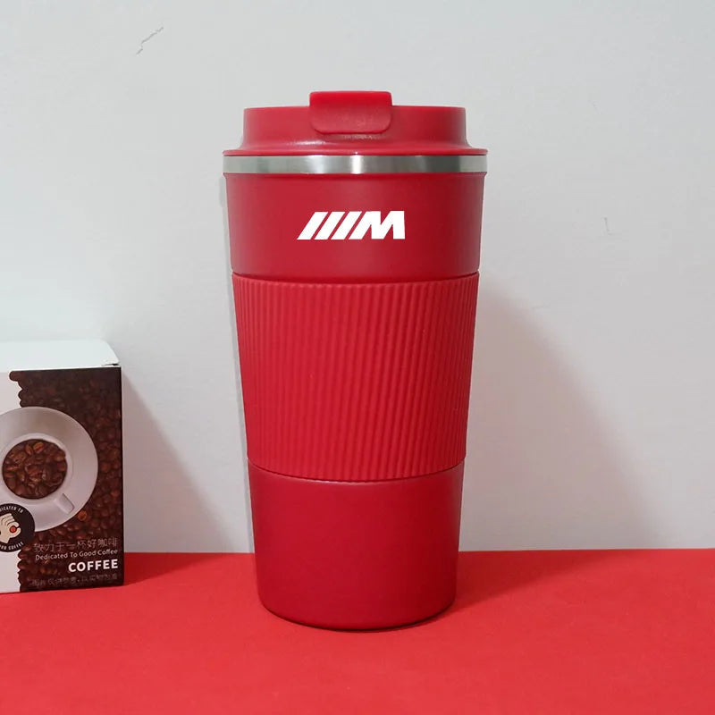 Red BMW M Sport travel mug with open lid, shown next to an empty box.