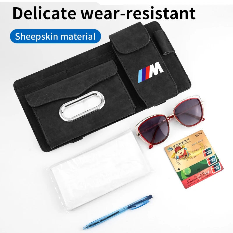 Black leather sun visor holder for BMW: stores sunglasses and pen.