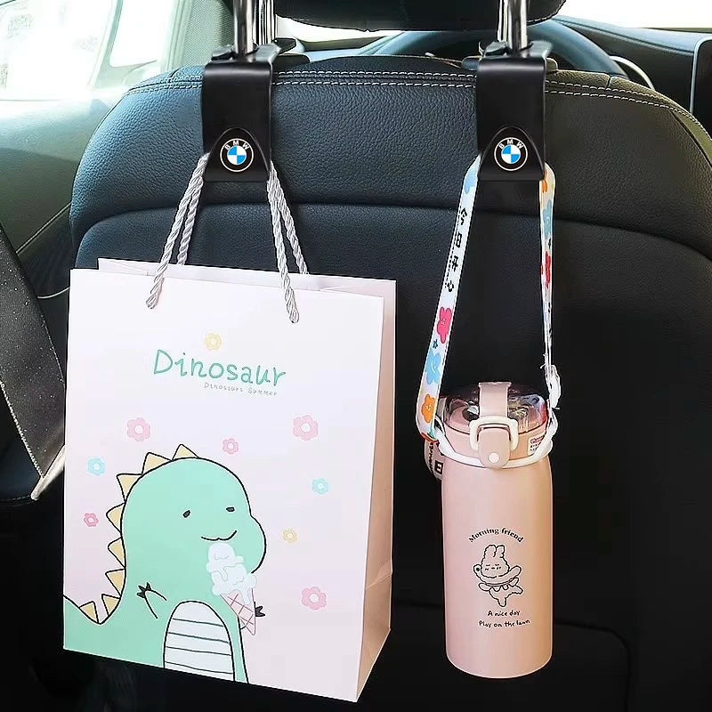 Two reusable shopping bags suspended from the rear of a vehicle, ready for use.