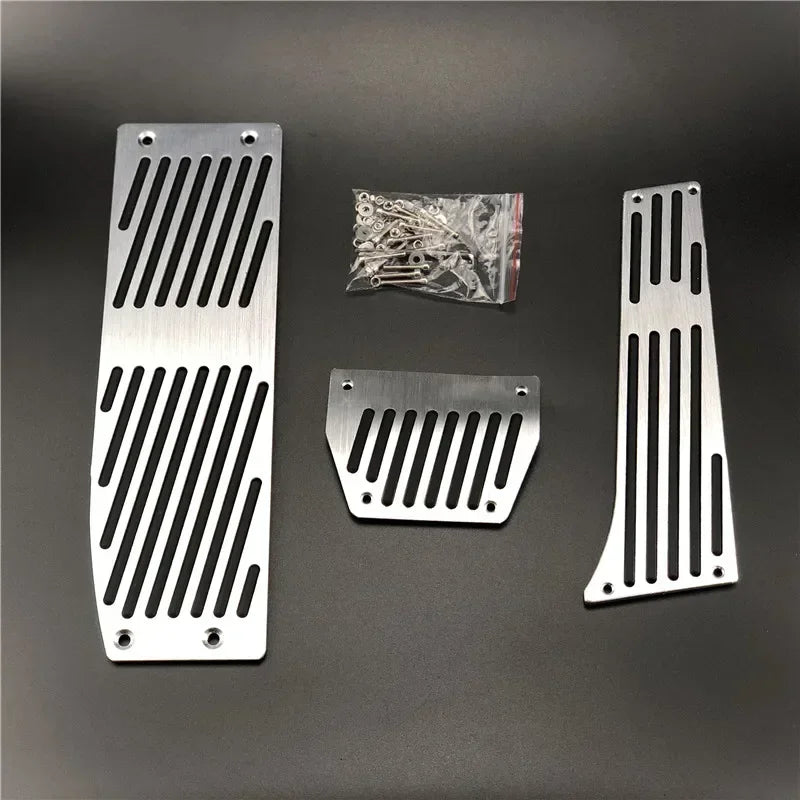 "Aluminum foot covers (silver/black) for BMW models E30, E36, E46, E90, M3, and X1. Fits front and rear pedals."