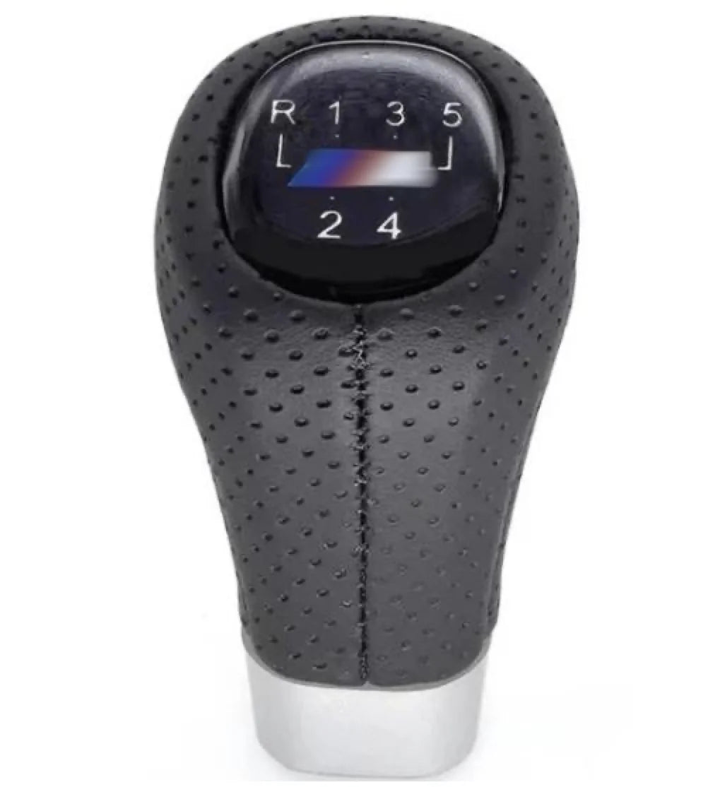 Black and white dashboard with BMW M Sport leather gear shift knob featuring blue illuminated tip.