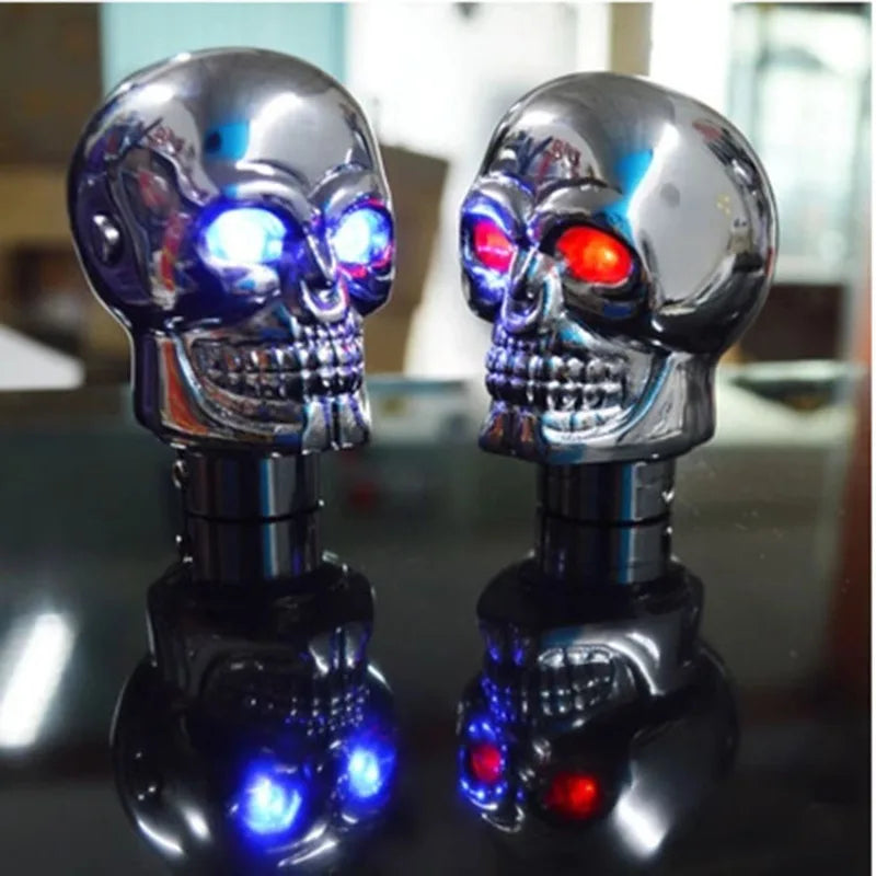Two skulls with integrated red and blue LED lights on a universal metal gear shift knob. (Auto/Manual compatible.)