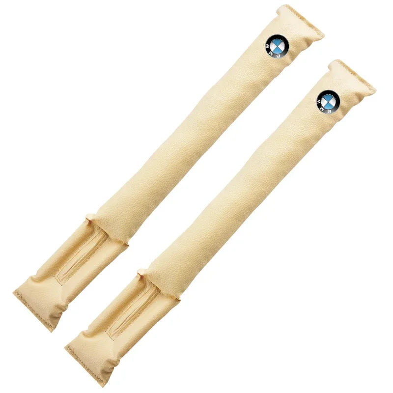 Two beige leather BMW seat gap fillers with a distinctive blue accent.