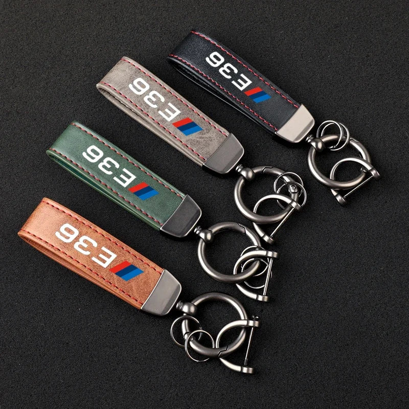 Three individual keychains made of genuine leather, each featuring a sturdy metal ring attachment.