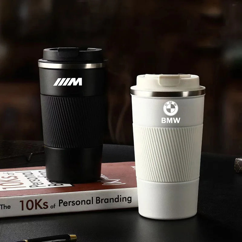 BMW M Sport Travel Mug: Sleek mug on table. Ideal companion for your morning brew during work or leisurely reading sessions. 