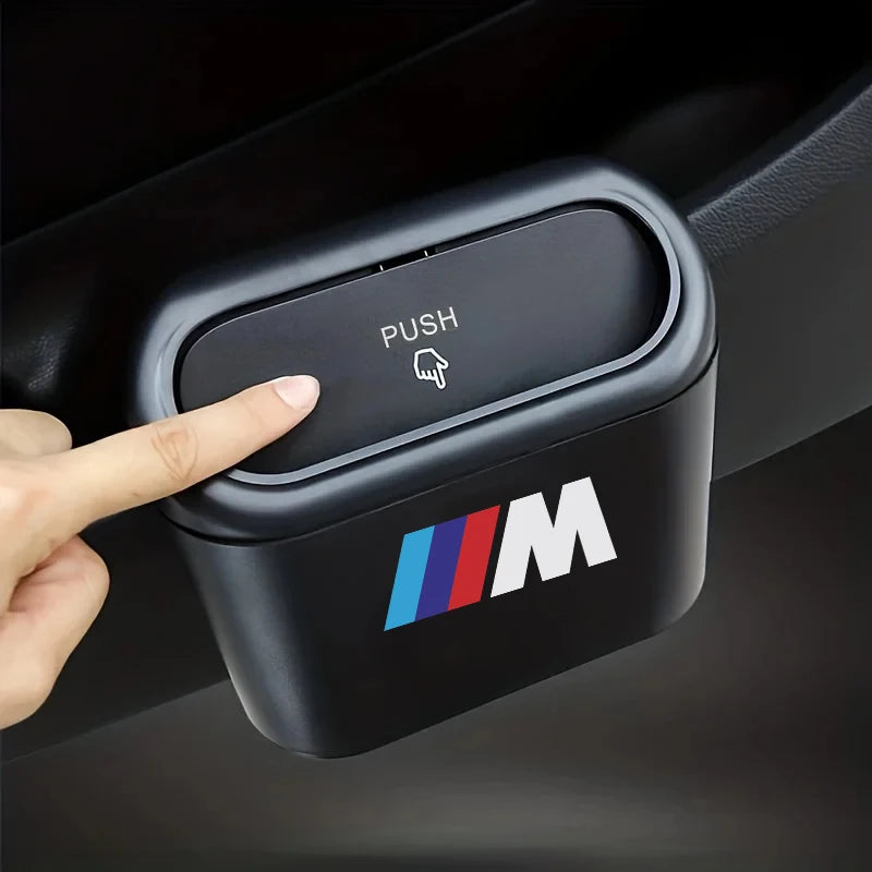 Person operating push button on BMW car dashboard for mini hanging trash can with lid (compatible with E36, E46, E90 X5 model