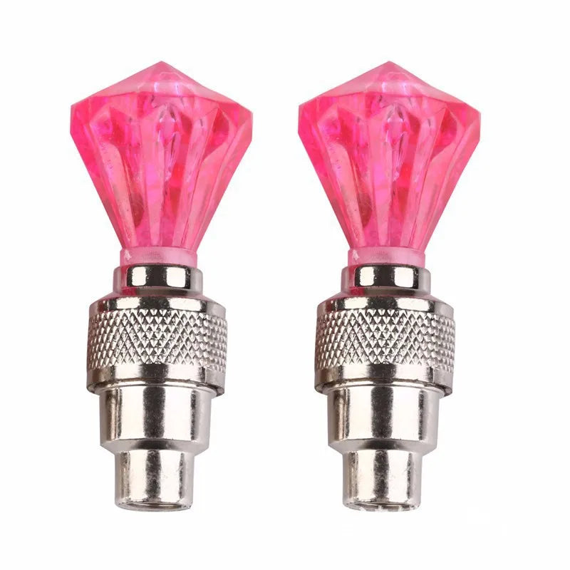 '2pc bicycle valve light - neon LED at tire valves. Pink crystal effect. Fits standard Schrader/Presta valves.'