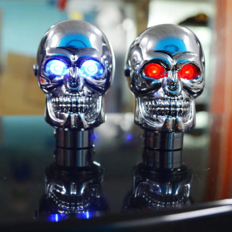 Two skulls with contrasting eye colors: one red, the other blue, adorn this universal LED gear shift knob.
