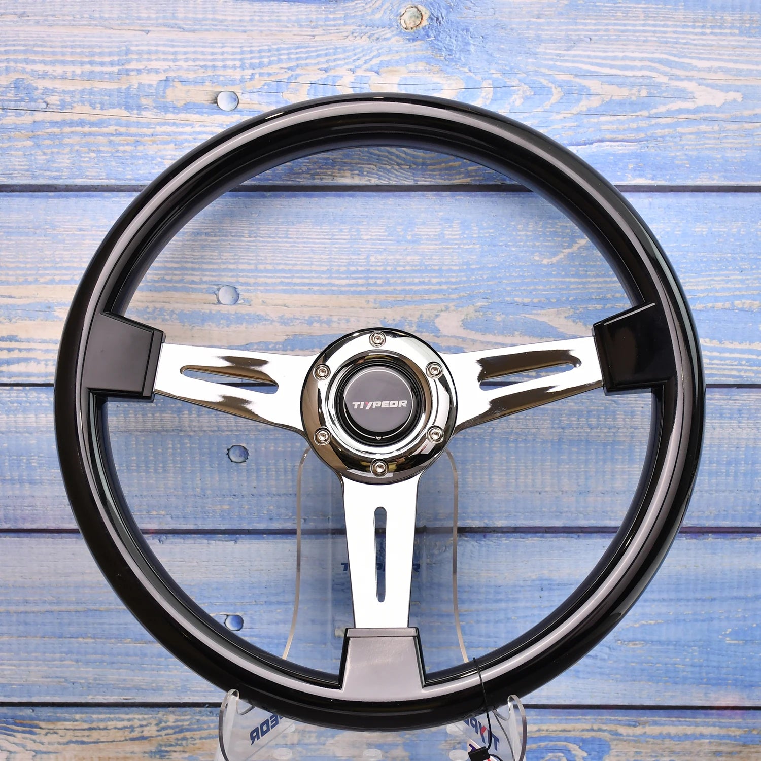 JDM-style universal steering wheel with forged bracket. Aluminum rim on natural wood background. Fits various makes. Measurem