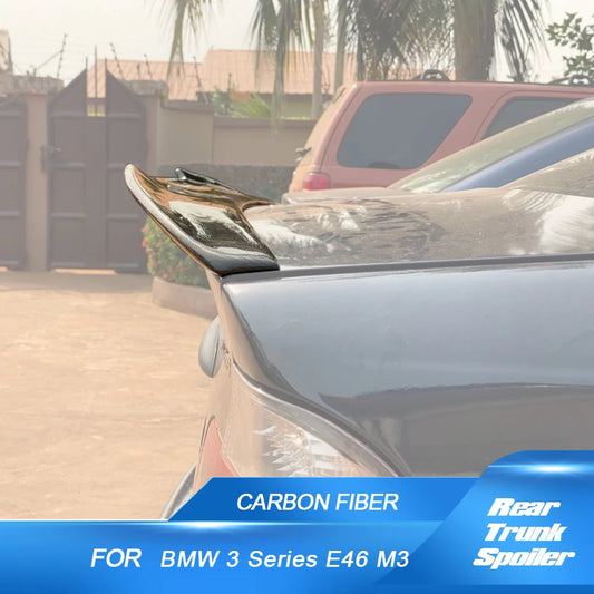 Carbon fiber Highkick Trunk Spoiler for BMW E46 Sedan '98-'05, displayed on a parked vehicle. No windshield damage present.