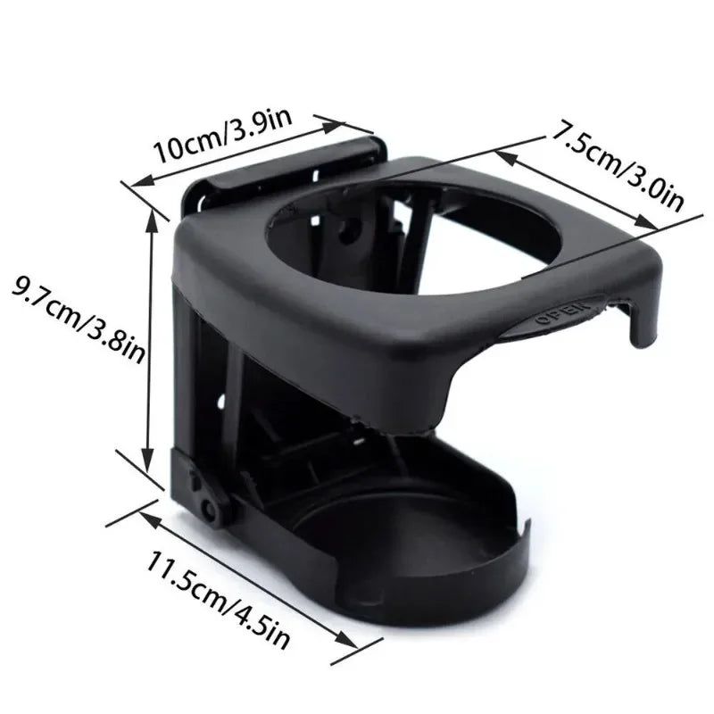 Black plastic coffee cup holder against white background. Mounts to car dashboard for beverage organization. Fits standard cu
