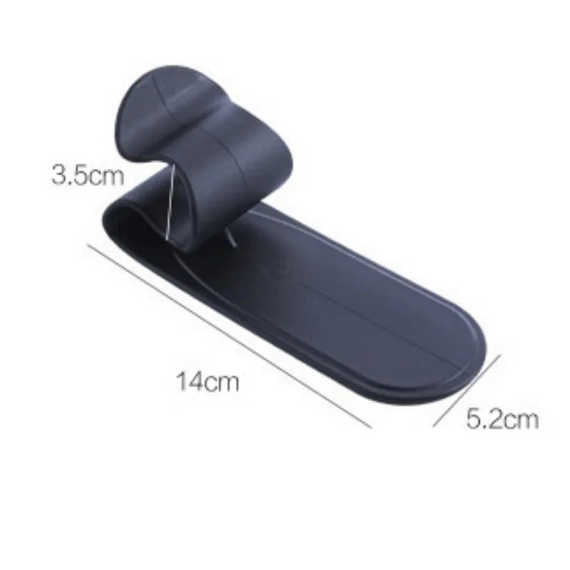 Black plastic umbrella holder on hook mount, fits all car trunks. Multifunctional design for convenience. Dimensions: 9x4x3 i