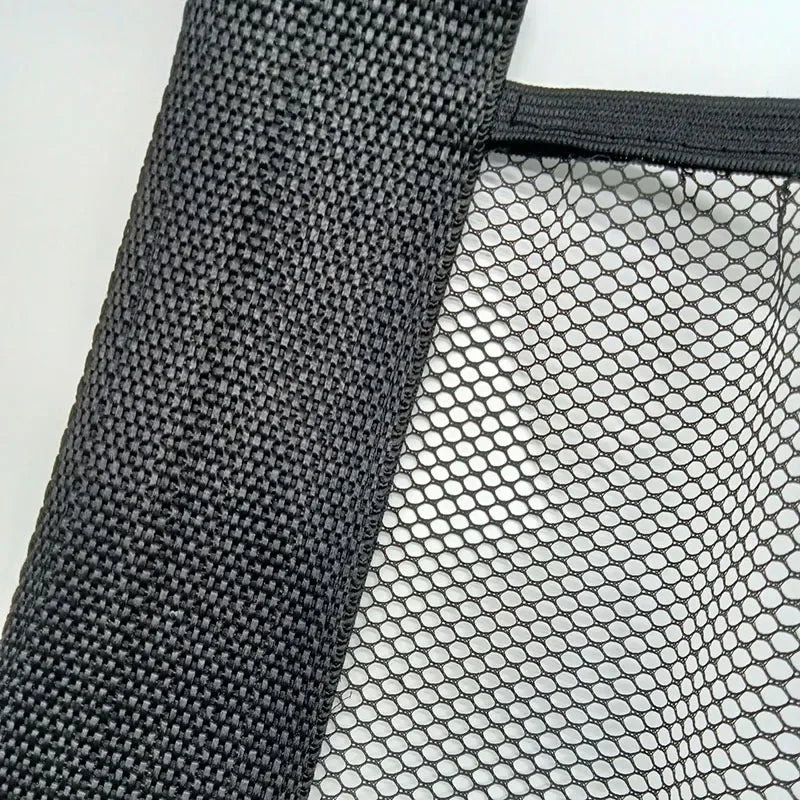 Black elastic mesh auto trunk organizer on white backing, enhancing car storage.