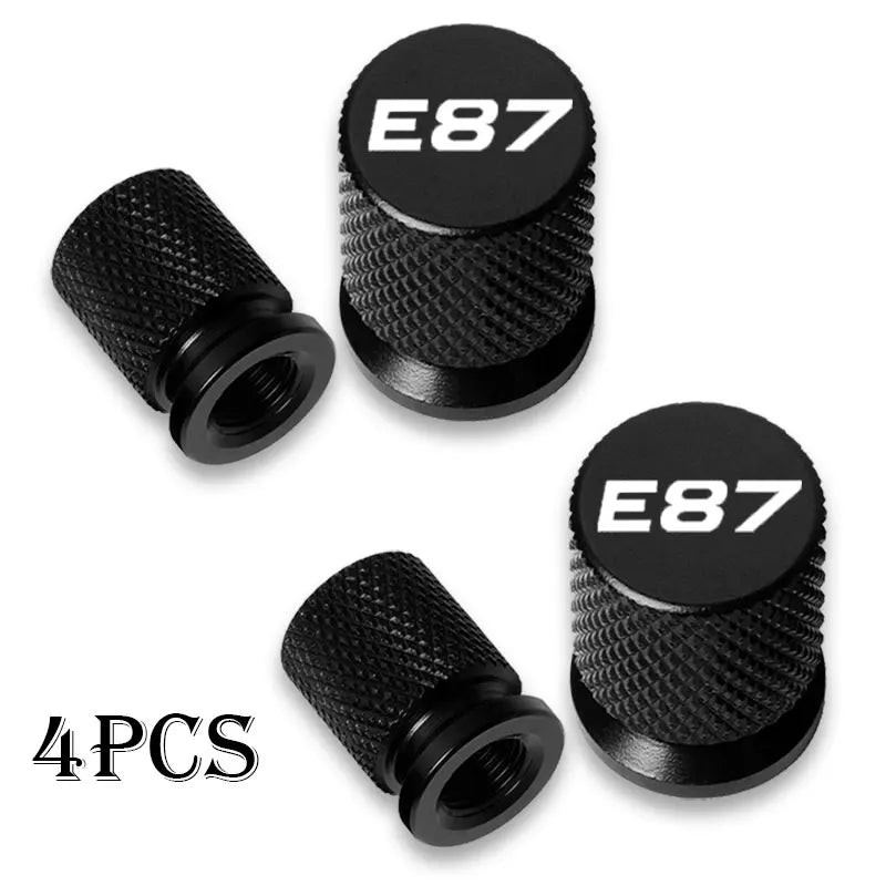 Four BMW E36/E46/E34 valve stem caps: black aluminum wheel covers. Replace worn or missing originals.
