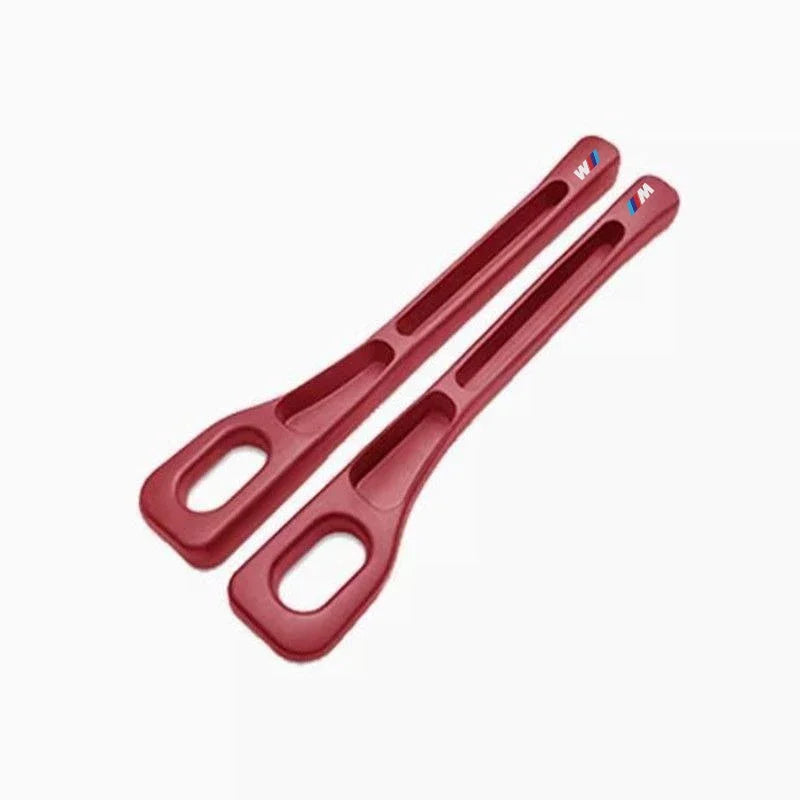 Two red plastic BMW seat gap fillers.

Or for more detail:
Two red plastic BMW seat gap fillers (2pc). Universal fit.