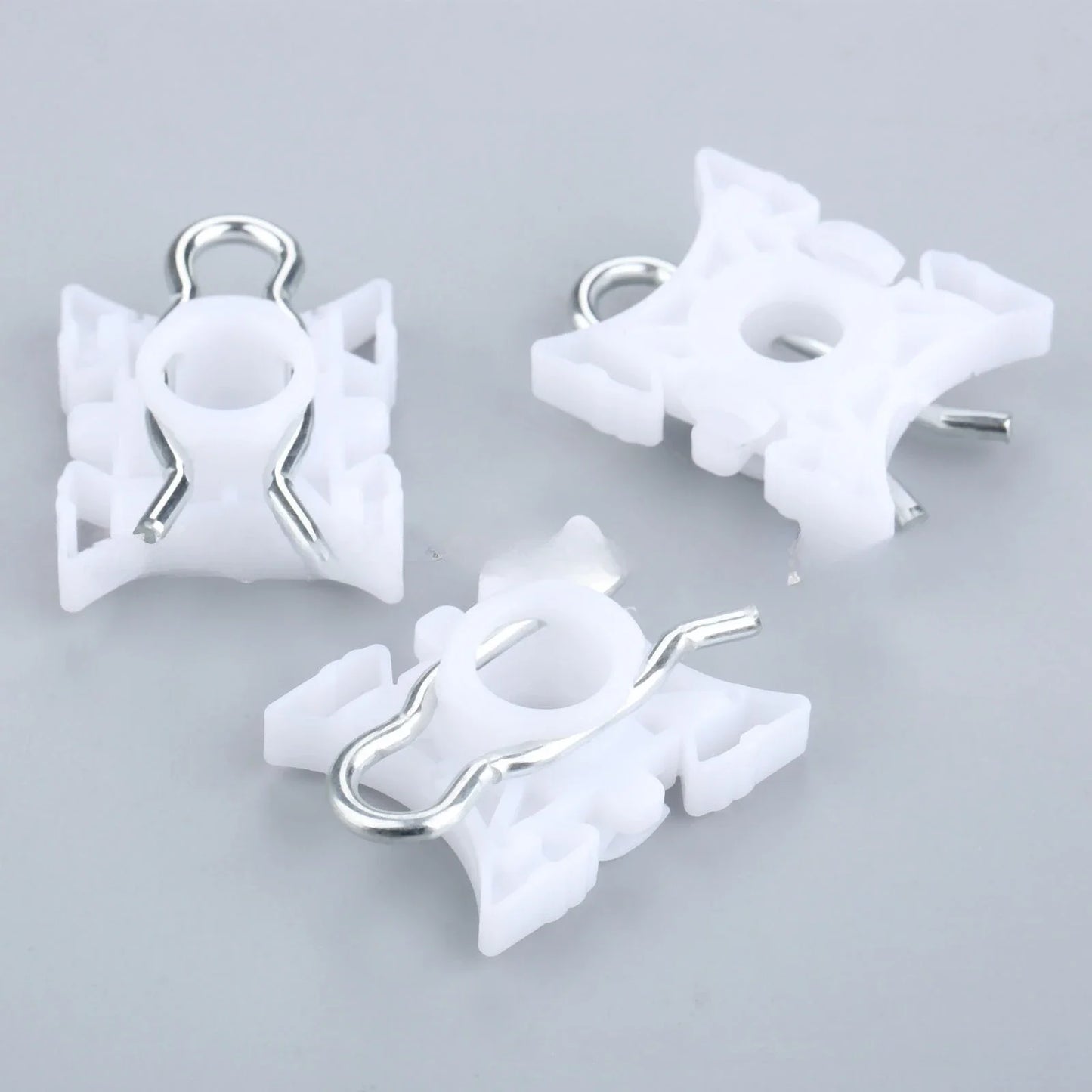 Ten white pivot clips for BMW E36 window regulators.