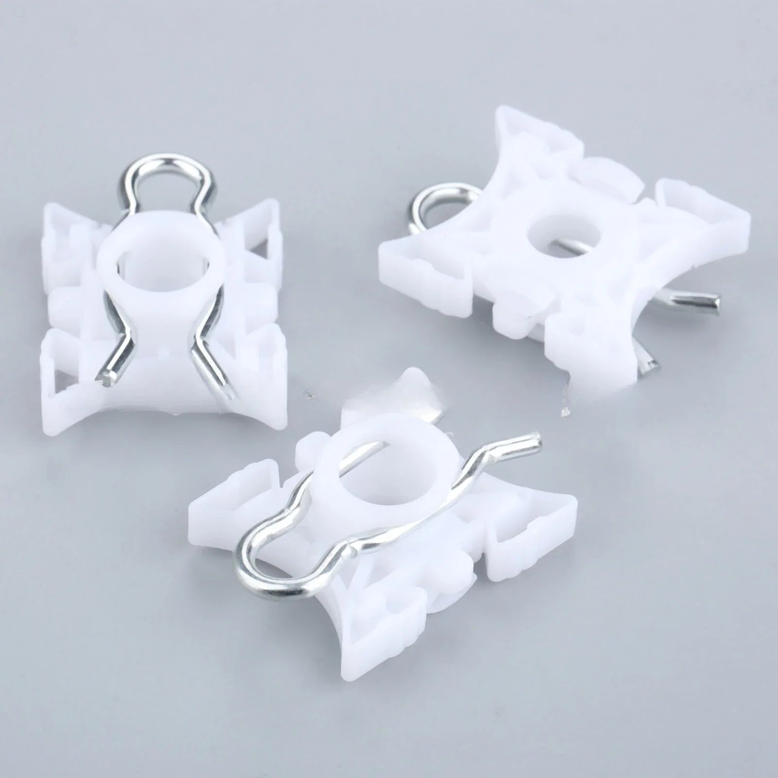 Ten white pivot clips for BMW E36 window regulators.