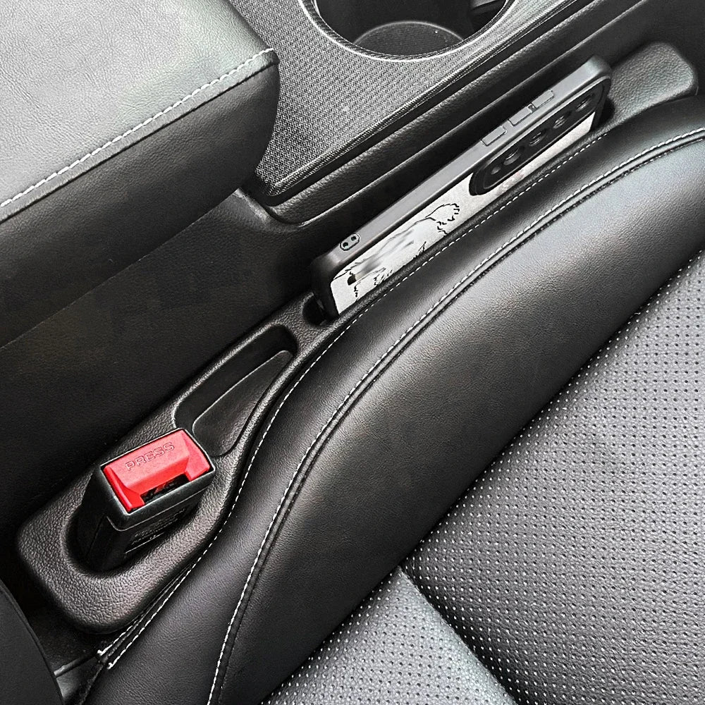 Red button car seat with black leather seat, includes one Universal Car Seat Gap Filler Strip.