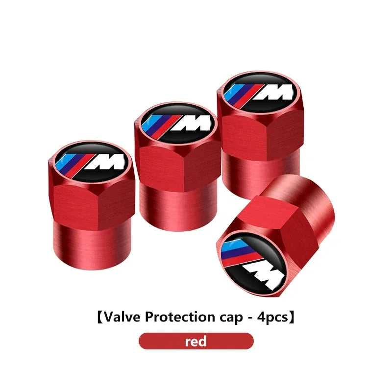Four red aluminum BMW M logo tire valve stem caps for E36 and E46 models.