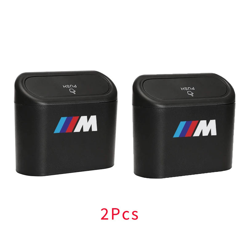 Two BMW M Logo emblems for embellishing a mini hanging car trash can with lid for BMW models E36, E46, and E90 X5.