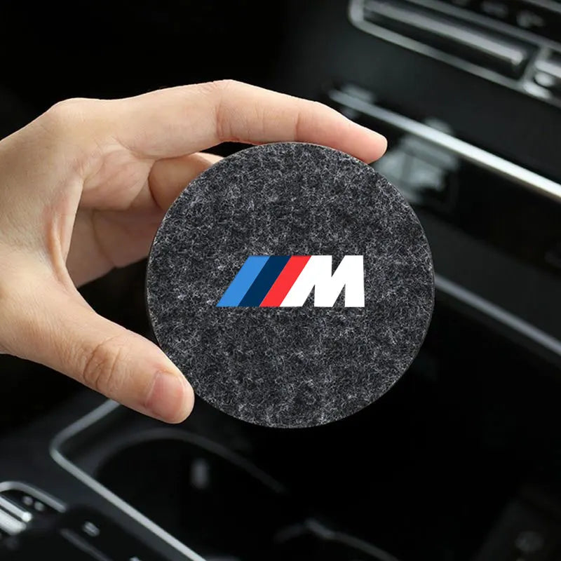 "Black round car coaster on a white background, ready for use."