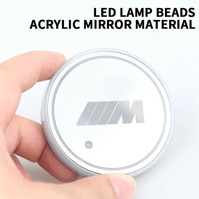 BMW M LED cup holder coaster with one glowing button.
