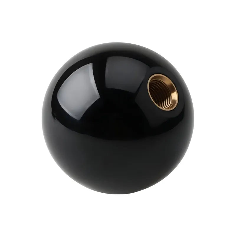 Black pool-style shift knob in matte black finish with brass adapter. Fits automatics universally. Diameter: 70mm approx.
