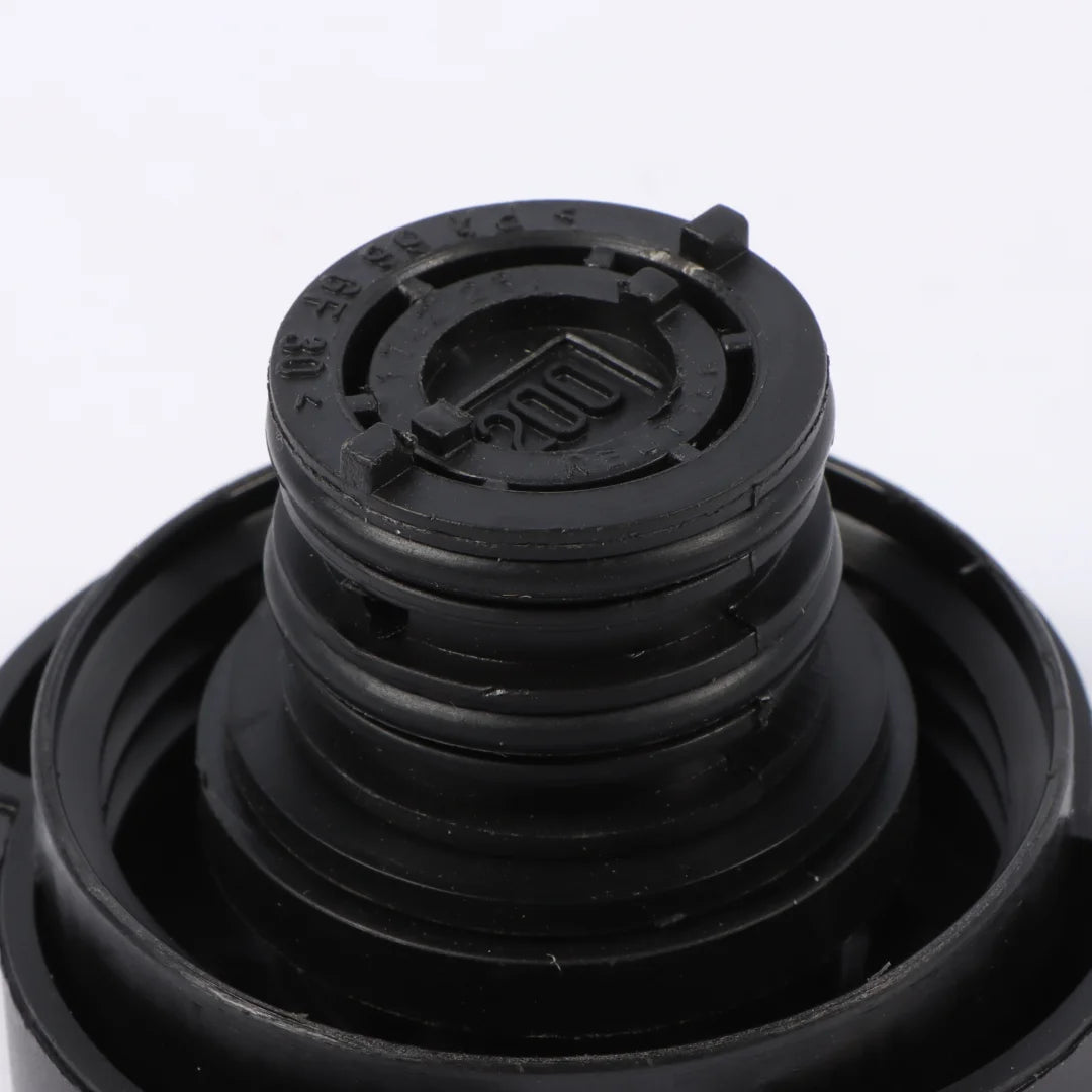 Black BMW radiator expansion tank cap with matching lid. (OE# 17111712669)