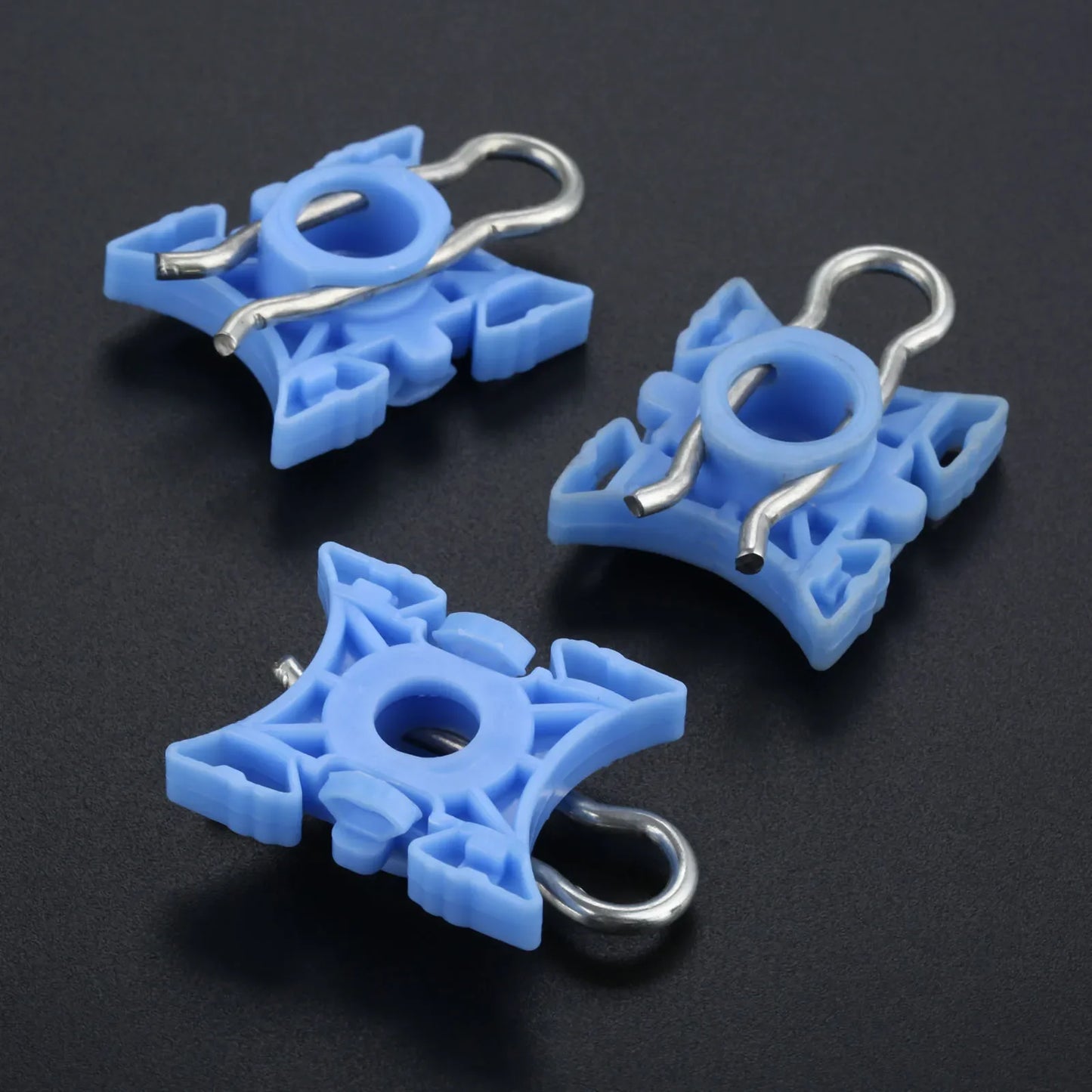 "BMW E36 Window Regulator Clips - Set of 10 in three shades of blue on a black background."
