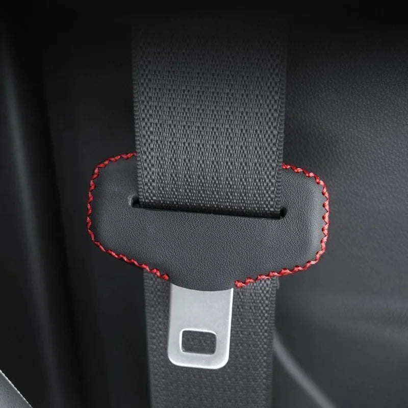 Red-stitched car belt with leather buckle protector. Anti-scratch accessory for upgraded interiors.