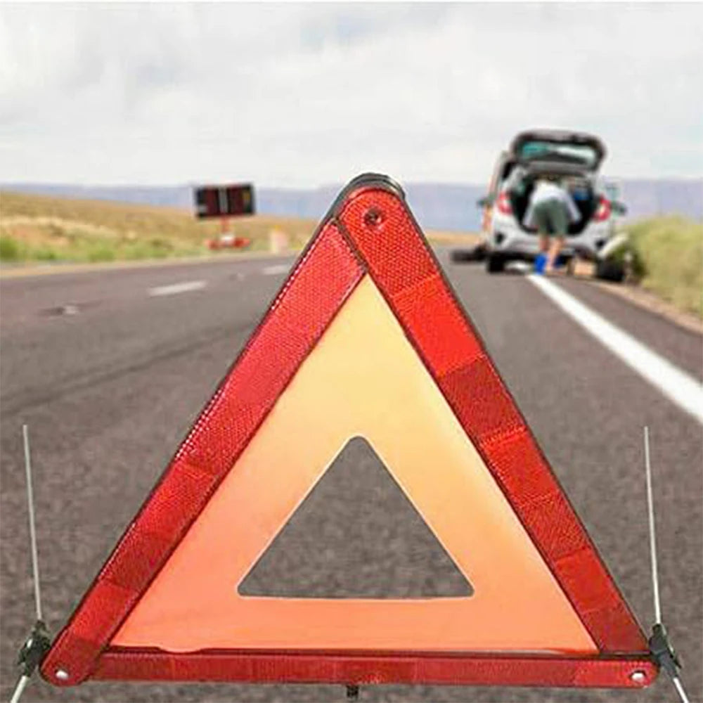 Red reflective emergency triangle on asphalt - road safety tool for accidents or breakdowns. Measurements: H7.9 x W13.4 x D0.