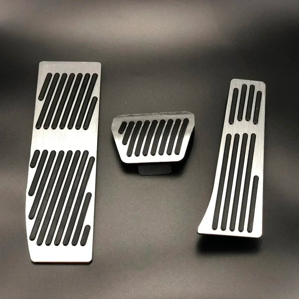 "Aluminum BMW pedal covers: silver base with black and white accents for E30, E36, E46, E90 M3 models."