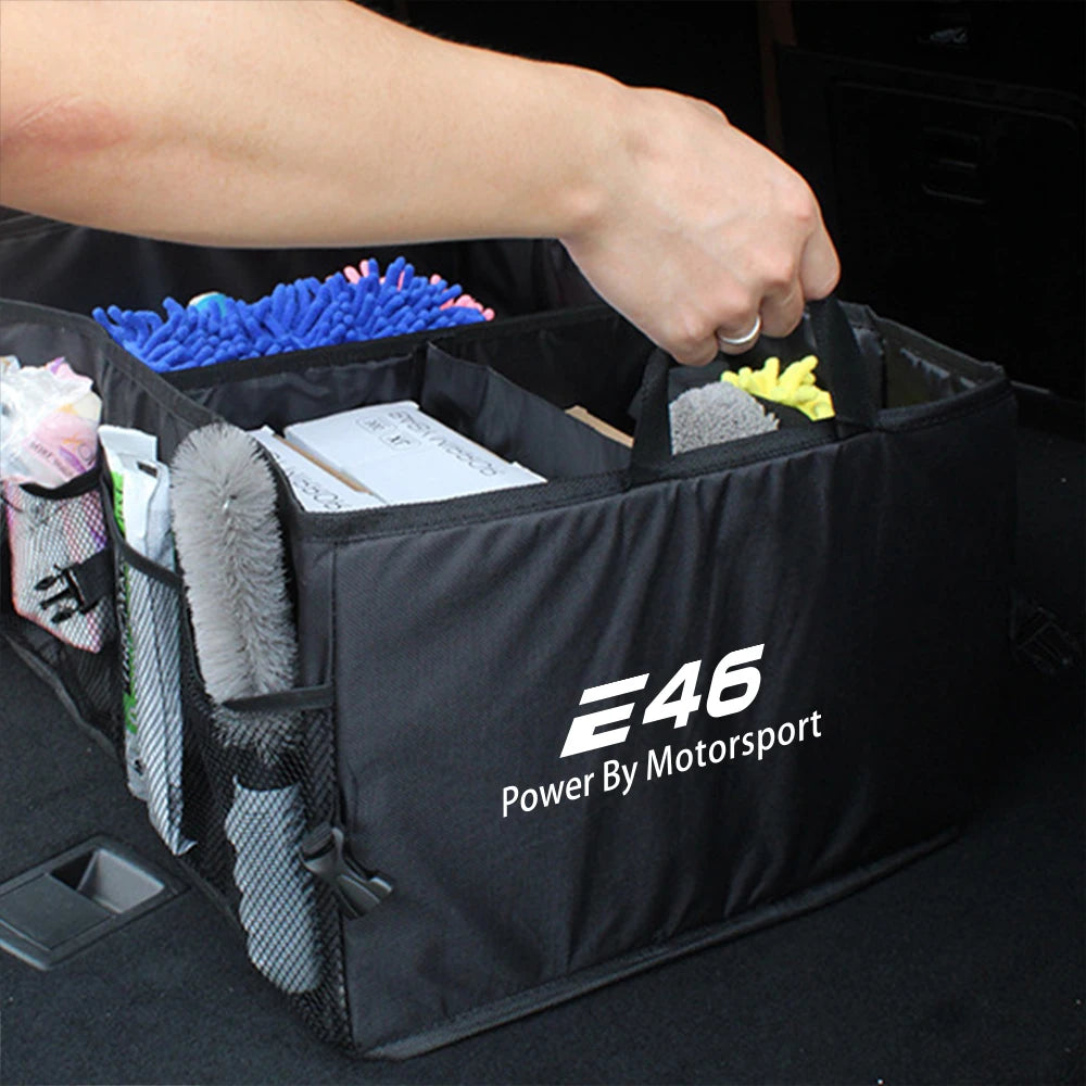 Person loading bag into BMW trunk storage box organizer.

Or:

BMW E36 E39 E46 trunk: Bag being inserted into organizational 